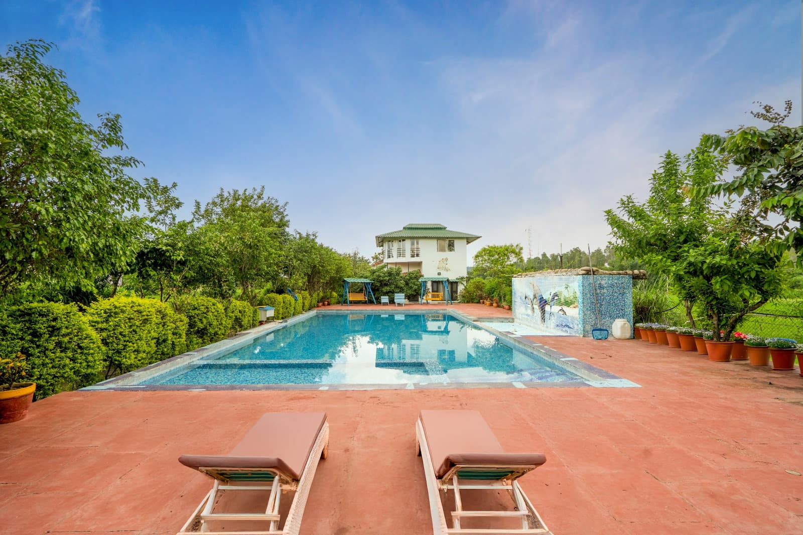 Swimming pool area at Corbett Treat Resort in Jim Corbett